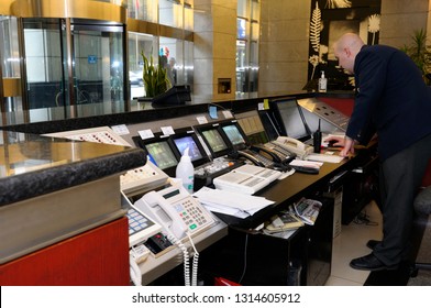 Toronto, Ontario, Canada - May 27, 2009: Security Guard At The Control Desk With Phones And Monitors In Highrise Office Building