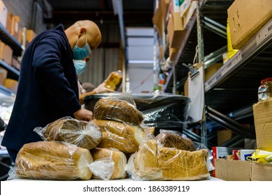 TORONTO, ONTARIO, CANADA - NOVEMBER 25, 2020: PEOPLE WORK AT JEWISH FOOD BANK, PREPARING FOOD FOR FAMILIES IN NEED OF HELP DURING COVID-19 PANDEMIC. 
