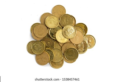 Toronto Ontario / Canada October 20 2019: overhead view a pile of Canadian dollar loonies coins isolated on white