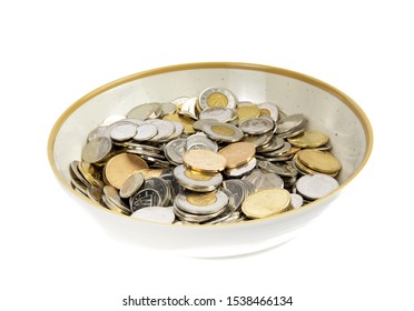 Toronto Ontario / Canada October 20 2019: a bowl full of Canadian currency coins isolated on white