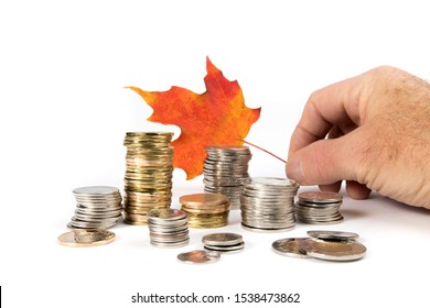 Toronto Ontario / Canada October 20 2019: Rough Stacks Of Canadian Dollar, Quarter, Dime And Two Dollar Coins With  A Red Maple Leaf Isolated On White