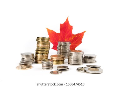 Toronto Ontario / Canada October 20 2019: Rough Stacks Of Canadian Dollar, Quarter, Dime And Two Dollar Coins With A Red Maple Leaf Isolated On White