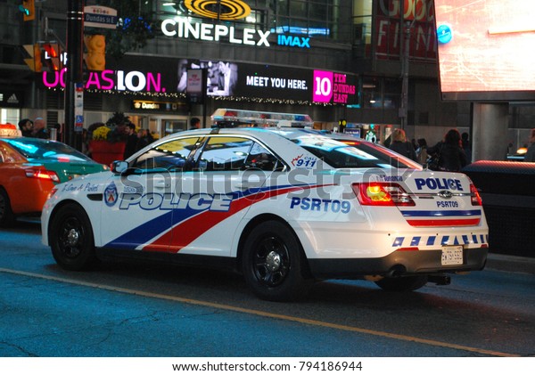 TORONTO, ONTARIO, CANADA - October 27 2017 -
Police Car In The City At Night, Emergency Vehicle at Dundas
Square, Police
Officers