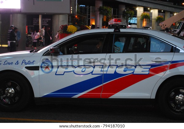 TORONTO, ONTARIO, CANADA - October 27 2017 -\
Police Car In The City At Night, Emergency Vehicle at Dundas\
Square, Police\
Officers