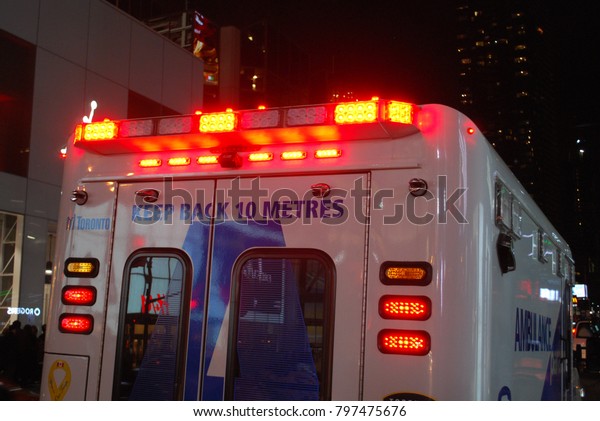 TORONTO, ONTARIO, CANADA - October 27 2017 -
Ambulance At Dundas Square on Yonge Street, city, 911, Emergency,
crash, Accident on the road, injuries, paramedics with stretcher,
flashing lights, aid