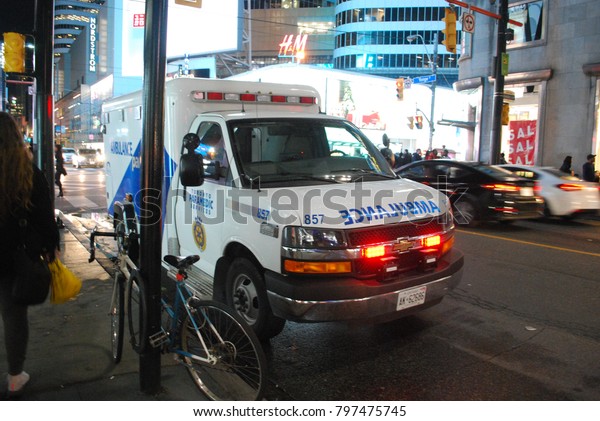 TORONTO, ONTARIO, CANADA - October 27 2017 -
Ambulance At Dundas Square on Yonge Street, city, 911, Emergency,
crash, Accident on the road, injuries, paramedics with stretcher,
flashing lights, aid