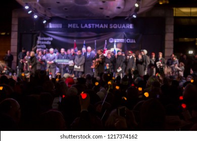 TORONTO, ONTARIO, CANADA - OCTOBER 29, 2018: People Hold Up Lit Candles At Vigil Held By Toronto Jewish Community For Victims Of Pittsburgh Synagogue Massacre