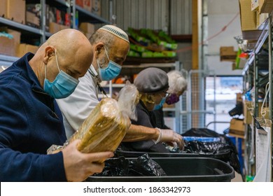 TORONTO, ONTARIO, CANADA - PEOPLE WORK AT JEWISH FOOD BANK, PREPARING FOOD FOR FAMILIES IN NEED OF HELP DURING COVID-19 PANDEMIC. 