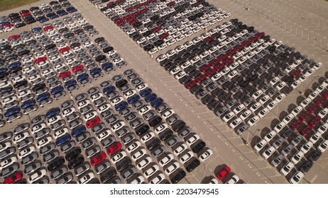 Toronto, Ontario, Canada – September 10, 2022: New Cars Located At The Factory Parking Lot Aerial View At Golden Hour. Car Manufactory Parking Area For A New Hybrid EV. Green Electric Vehicles.