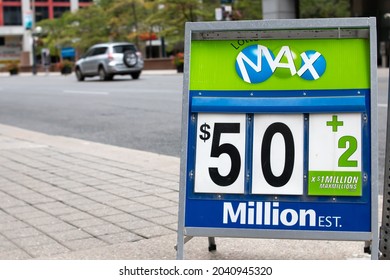 Toronto, Ontario, Canada - September 12 2021: A Lotto Max sign advertises a 50 million dollar jackpot on Front Street, Toronto during the pandemic.
