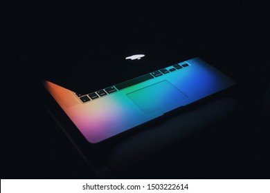Toronto, Ontario / Canada - September 13th 2019 : Photograph of a MacBook Pro and its colourful wallpaper, screen is almost closed.