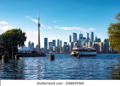 Toronto, Ontario, Canada, View Of Iconic Toronto Skyline Showing Ferry Boat Arriving At Centre Island By Day In Fall Season.