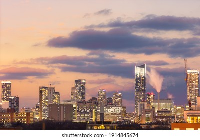 Toronto, Ontario - February 8 , 2021 : Toronto skyline with condos and high rises lit up as the last color from sunset dissipates. 