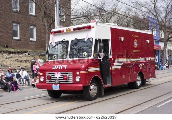 TORONTO, ONTARIO/CANADA - APR\
16, 2017: the vintage fire truck decorated with bunny ears, nose\
and bowtie driven along the Beaches Queen Street in the Easter\
Parade