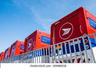 TORONTO, ONTARIO/CANADA - MAY 16, 2010: Canada Post Mail Vehicles Parked Outside A Sorting Facility.