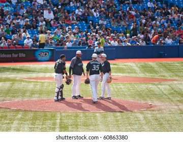 TORONTO - SEPT 11:  Blue Jays Coach Cito Gaston Consults With Pitcher David Purcey, First Baseman Lyle Overbay, And Catcher Jose Molina Against The Tampa Bay Rays, September 11, 2010 In Toronto.