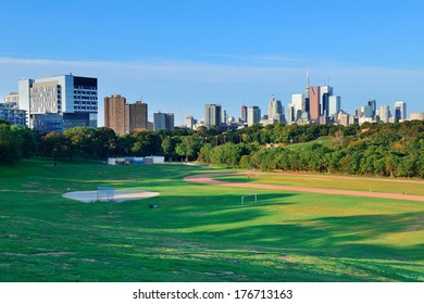 Toronto Skyline Over Park With Urban Buildings And Blue Sky