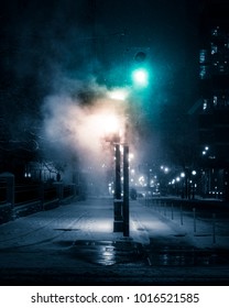 TORONTO WINTER SCENE - Steam/smoke Covering Downtown City Traffic Lights At Night. Urban Toronto Streets, With Snow On Ground And Feeling Of Mystery. Toronto, Ontario, Canada.