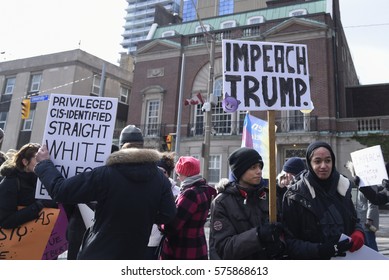 TORONTO-FEBRUARY 4: A protester asking for "impeachment of Trump" during a protest in front of the US Consulate to denounce Donald Trump's immigration policies on February  4, 2017 in Toronto, Canada.