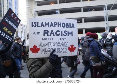 TORONTO-FEBRUARY 4:People with posters rejecting racism & Islamophobia during a protest in front of the US Consulate to denounce Trump's immigration policies on February  4,2017 in Toronto, Canada.