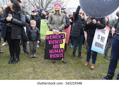 TORONTO-JANUARY 21:An old woman with sign, equaling  women's rights as human rights during the "Women's March on Washington" to protest against Trump presidency on January 21, 2017 in Toronto, Canada.