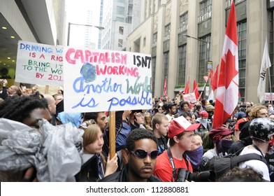 TORONTO-JUNE 26:   Protesters Carrying Signs  Denouncing Capitalism And Asking For 