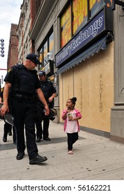 TORONTO-JUNE 27: Friendly Interaction Between Policemen And Little Girl On Toronto Street During G20 Protest June 27, 2010 In Toronto.