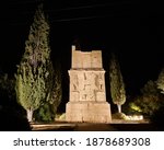 Torre dels Escipions (Scipio brothers), stone tower ancient funerary tower built by the Romans on the outskirts of Tarraco, ancient Roman city, monument lit at night. Tarragona, Catalonia, Spain