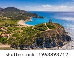 Torre di Chia view from flying drone. Acropoli di Bithia with Torre di Chia tower on background. Aerial view of Sardinia island, Italy, Europe. Panorama Of Chia Coast, Sardinia, Italy. 