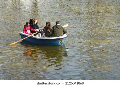 Torrejon de Ardoz, Spain; 2 12 2022: Family riding in rowboats in a park
