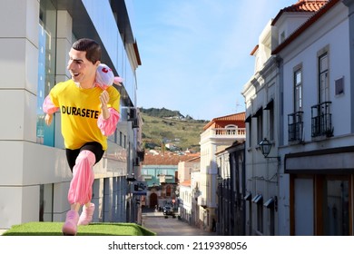 Torres Vedras, Portugal - February 2022: The famous Torres Vedras carnival - traditional figures with huge heads are called "Cabezudos". Portuguese footballer Cristiano Ronaldo in a battery suit. 