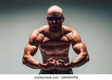 The Torso Of Attractive Male Body Builder  Flexing His Muscles In Studio Shot. Concept Gym Life Style.