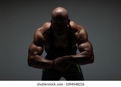 The Torso Of Attractive Male Body Builder Flexing His Muscles In Studio Shot. Concept Gym Life Style.