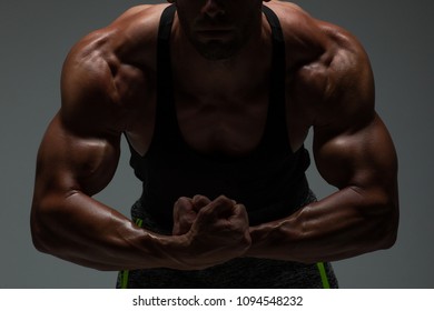 The Torso Of Attractive Male Body Builder Flexing His Muscles In Studio Shot. Concept Gym Life Style. 