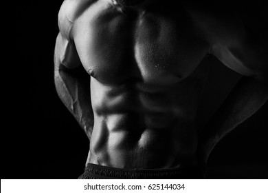 The Torso Of Attractive Male Body Builder On Black Background.