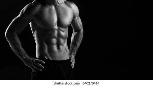 The Torso Of Attractive Male Body Builder On Black Background.