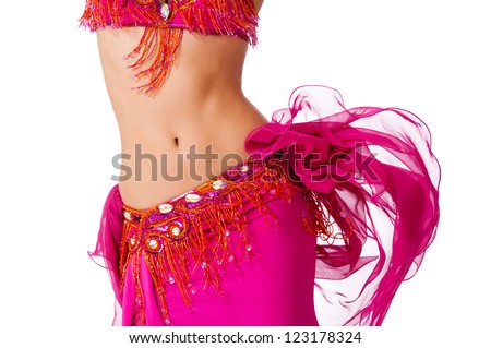 Torso of a female belly dancer wearing a hot pink costume shaking her hips. Isolated on white.