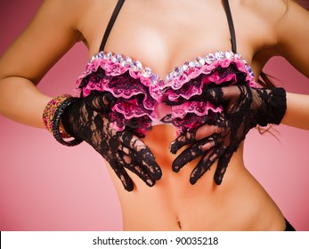 Torso  of a female dancer wearing black and pink lace lingerie