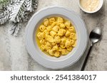 Tortellini in beef and chicken or capon broth. Traditional Italian Christmas main course especially in Bologna. Pasta stuffed with a mix of meat, prosciutto, mortadella, parmesan cheese.