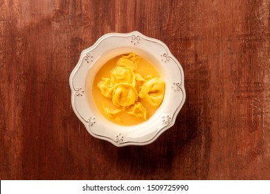 Tortellini With Broth, Overhead Shot On A Dark Rustic Wooden Background