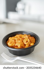 Tortellini pasta with rosa sauce and a plastic fork. Shallow depth of fields and copy space for your text.
