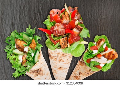 Tortilla Chicken Wrap Sandwich On Wooden Background.