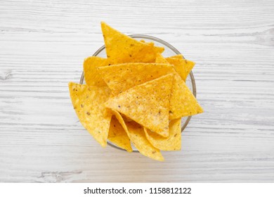 Tortilla Chips In A Bowl On White Wooden Table, Overhead View. Mexican Food. 