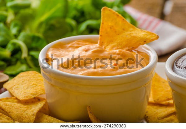 Tortilla\
chips with cheese dip and barbecue, czech\
beer
