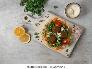 Tortilla With Falafel And Vegetable Salad, White Sauce, Arabic Cuisine, Top View, Homemade, No People, Vegetarian Food,