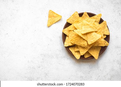 Tortilla or Nacho Chips for snack. Mexican Corn Chips Nachos on white background, top view, copy space. 
