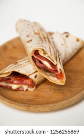 tortilla wrap with red peppers, cheese, tomatoes and fresh basil leaves