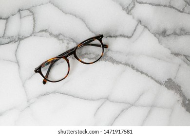 Tortoise Shell Glasses On Marble Background, Copy Text