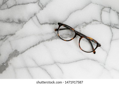 Tortoise Shell Glasses On Marble Background, Copy Text