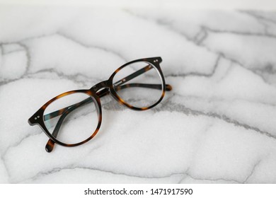 Tortoise Shell Glasses On Marble Background, Copy Text